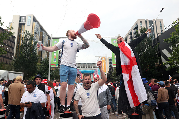 LONDON, ENGLAND - JULY 11: A fan of England sings into a traffic cone as they show their support outside the stadium prior to the UEFA Euro 2020 Championship Final between Italy and England at Wembley Stadium on July 11, 2021 in London, England. (Photo by Alex Pantling/Getty Images)