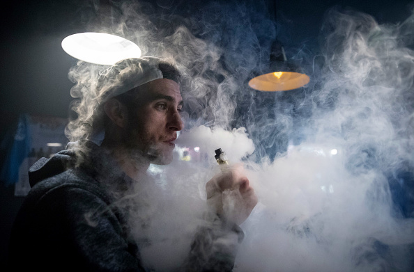 BRISTOL, ENGLAND - DECEMBER 30:  Mitchell Baker who works at the Vapour Place a vaping shop in Bedminster, exhales vapour produced by an e-cigarette on December 30, 2016 in Bristol, England. Recent figures released by the e-cigarette industry has claimed that there as many as 1700 vaping shops across the country, with two new ones opening each day catering for the estimated three million vapers in the UK. The popularity of e-cigarettes has boomed in the last ten years, as it is seen by many as a healthier alternative to traditional cigarettes, however some critics say the devices can carry the same risks as smoking especially as the long term affects are yet to be known.  (Photo by Matt Cardy/Getty Images)
