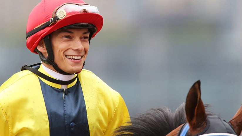 Alexis Badel poised at Happy Valley Racecourse, focused on upcoming races, highlighting his successful jockey career in Ho...