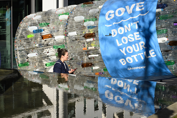 Greenpeace Activists Deliver A Giant plastic Bottle to The Department For The Environment To Highlight Plastic Pollution