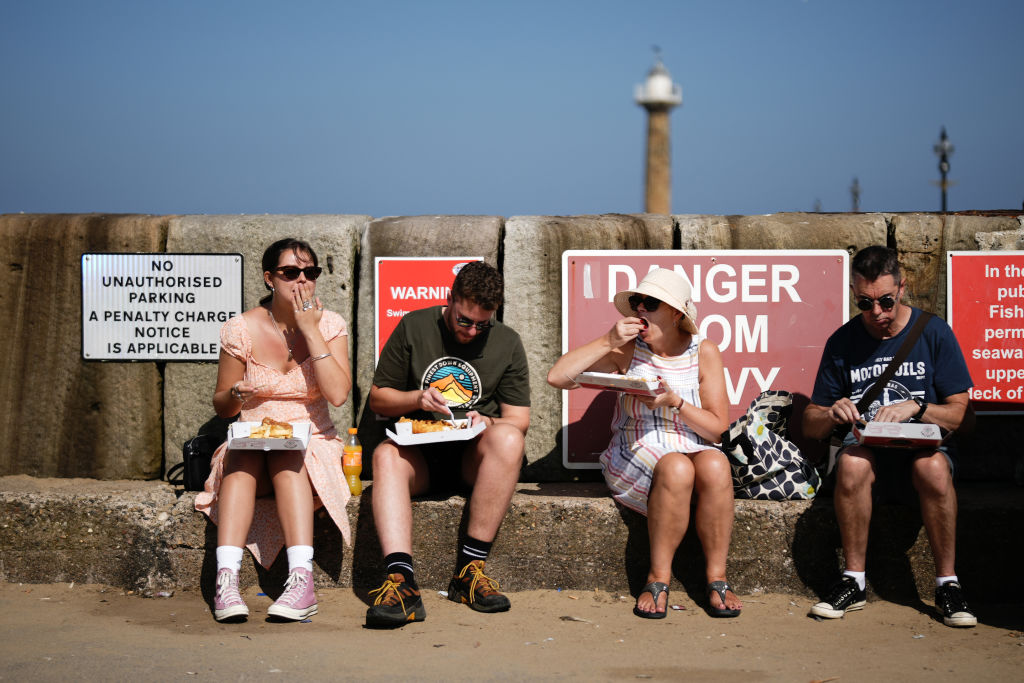 WHITBY, UNITED KINGDOM - SEPTEMBER 08: People eat fish and chips and take away food on a busy 'staycation'  day in fine weather on September 08, 2021 in Whitby, United Kingdom. Hospitality sector businesses across England are recovering from the twin disruptions of Covid-19 and Brexit. (Photo by Christopher Furlong/Getty Images)