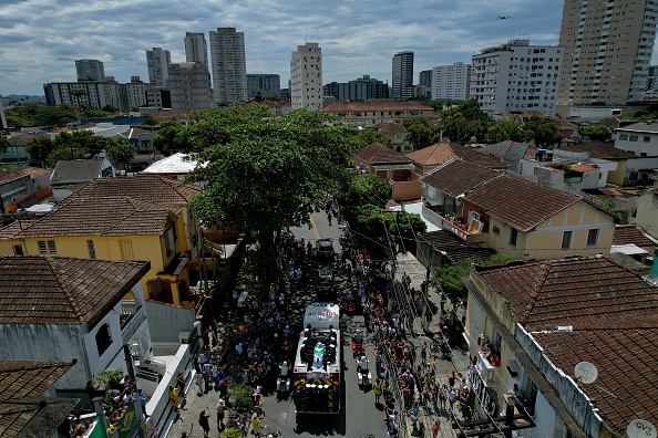 After lying in state, Pele's coffin was carried through the streets of Santos ahead of his family-only funeral later on Tuesday