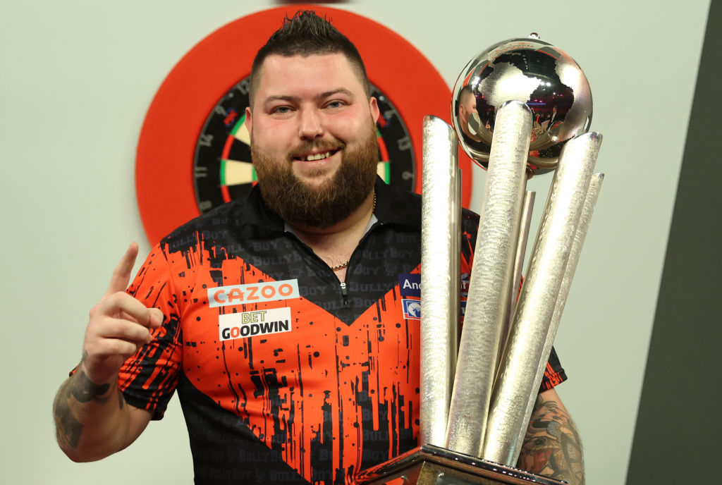 LONDON, ENGLAND - JANUARY 03: Michael Smith of England celebrates with the Trophy during the Finals against Michael van Gerwen of Netherlands during Day Fourteen of the Cazoo World Darts Championship at Alexandra Palace on January 03, 2023 in London, England. (Photo by Luke Walker/Getty Images)