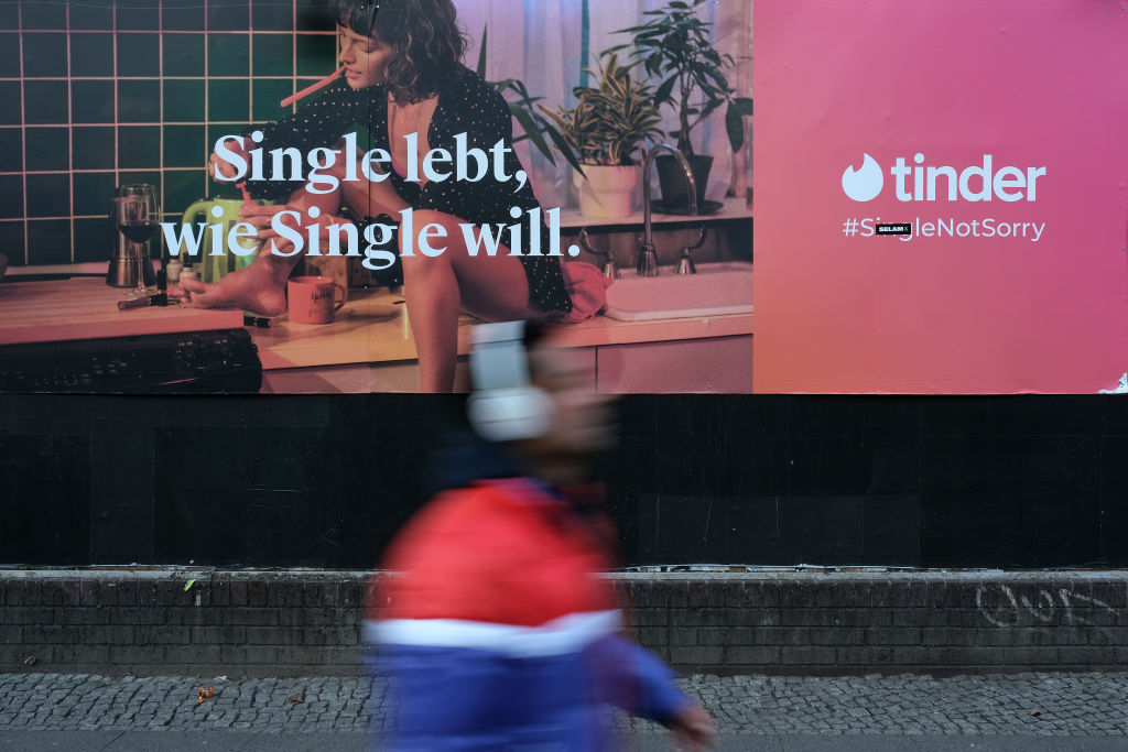 BERLIN, GERMANY - FEBRUARY 18: A man walks past a billboard advertisement for the dating app Tinder that reads: "Single lives, as single wants." on February 18, 2019 in Berlin, Germany. Tinder has emerged as one of the most popular dating apps.  (Photo by Sean Gallup/Getty Images)