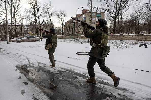 BAKHMUT, UKRAINE - FEBRUARY 14: Ukrainian soldiers scan an apartment block after hearing a shot fired while on patrol on February 14, 2023 in Bakhmut, Ukraine. Ukrainian forces have been holding the city as Russian Wagner paramilitary forces press a winter offensive, at great cost to both sides. (Photo by John Moore/Getty Images)