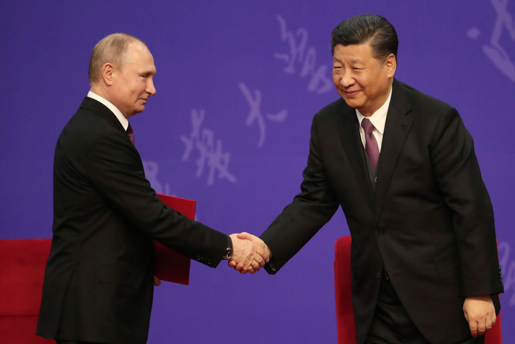 Russian President Vladimir Putin, left, shakes hands with Chinese President Xi Jinping in 2019   (Photo by Kenzaburo Fukuhara - Pool/Getty Images)