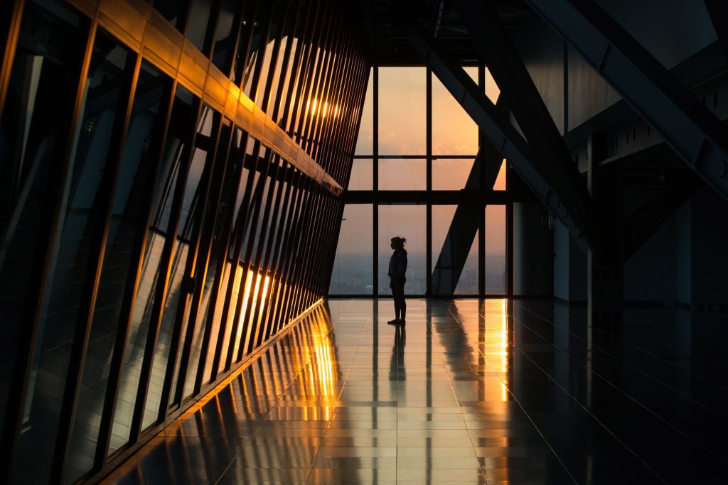 A woman looks out at the London skyline from an upper floor of a newly constructed skyscraper, The Leadenhall Building, as the sun sets on September 9, 2014 in London, England. The skyscraper, located in the City of London, has been dubbed the 'Cheesegrater' for its distinctive shape. The building stands at 224 meters high and was designed by 'Rogers Stirk Harbour + Partners'.  (Photo by Oli Scarff/Getty Images)