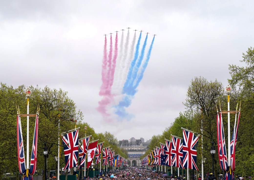 A general view of flypast by aircraft from the Red Arrows over the Mall following the coronation of King Charles III and Queen Camilla in London. 