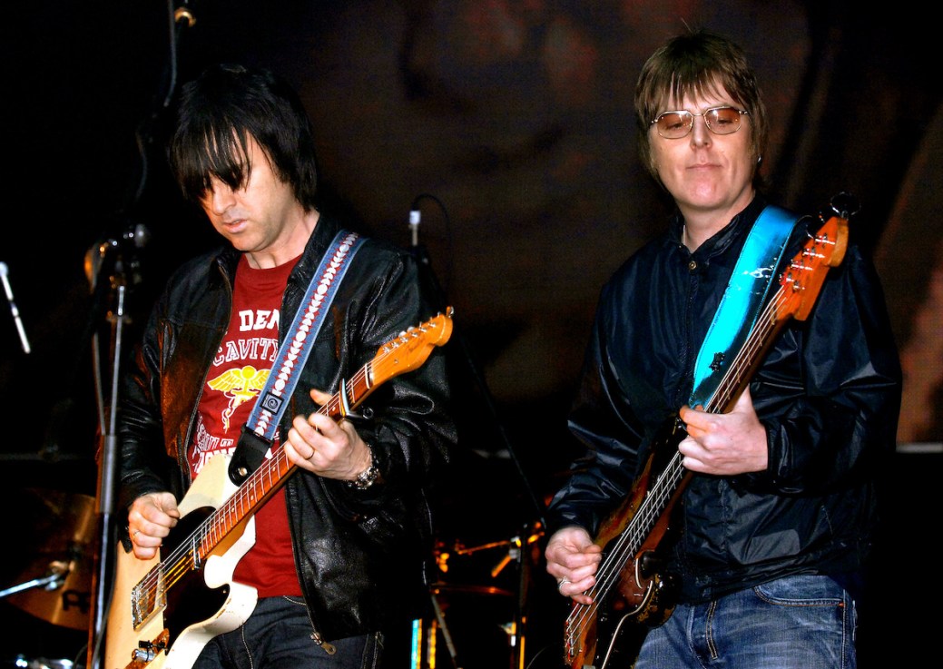Former members of The Smiths, Andy Rourke (right) and Johnny Marr, on stage during the 'Manchester Versus Cancer' charity concert, held at the Manchester Evening News (M.E.N.) Arena in Manchester. Mr Rourke has died aged 59 after a "lengthy illness with pancreatic cancer", his former bandmate Mr Marr has said. Issue date: Friday May 19, 2023. PA Photo. See PA story DEATH Rourke. Photo credit should read: Steve Parsons/PA Wire