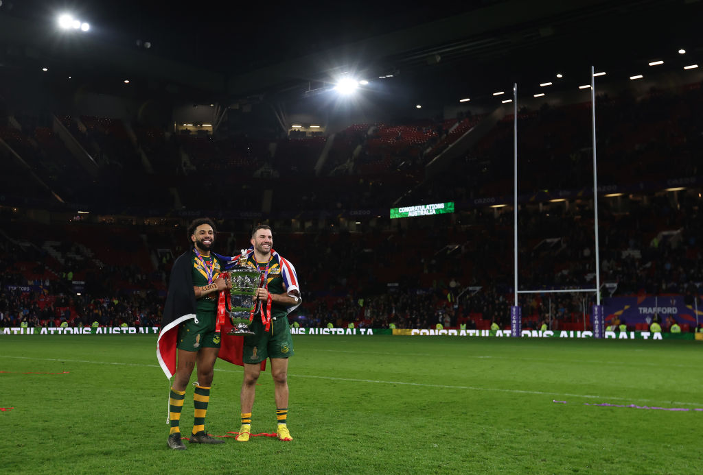 MANCHESTER, ENGLAND - NOVEMBER 19: Josh Addo-Carr and James Tedesco of Australia hold the Rugby League World Cup trophy following the Rugby League World Cup Final match between Australia and Samoa at Old Trafford on November 19, 2022 in Manchester, England. (Photo by George Wood/Getty Images)