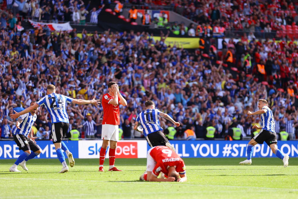 A 123rd-minute goal by Josh Windass saw Sheffield Wednesday beat Barnsley in the League One play-off final and return to the English Championship after two seasons in the third tier.