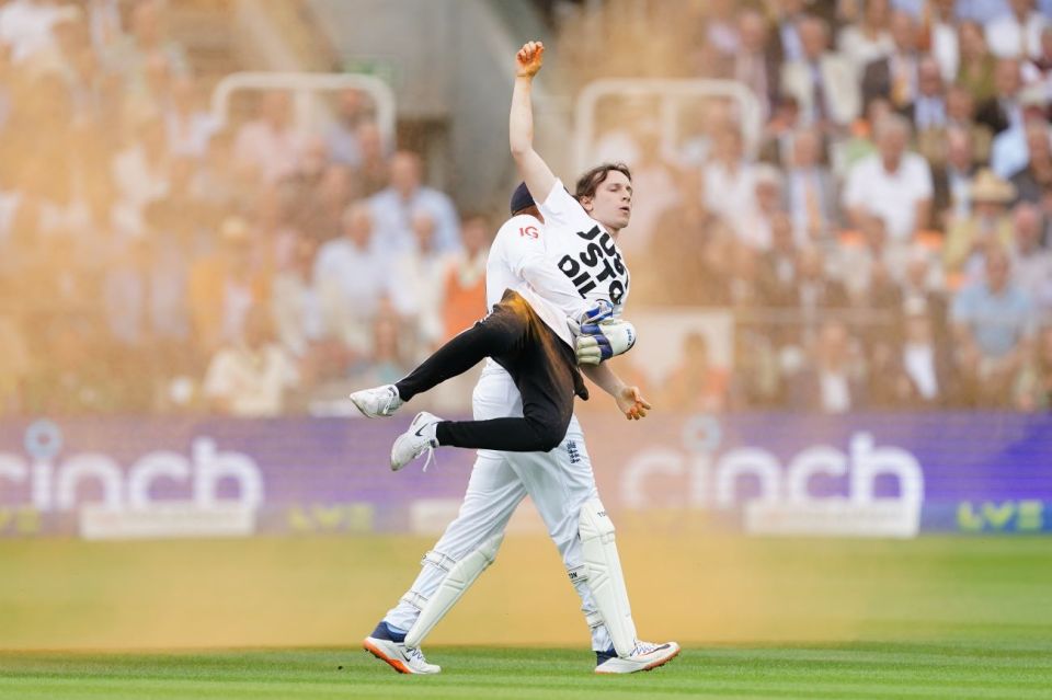 England's Johnny Bairstow carrying a Just Stop Oil protester off the pitch during day one of the second Ashes test match at Lord's, London