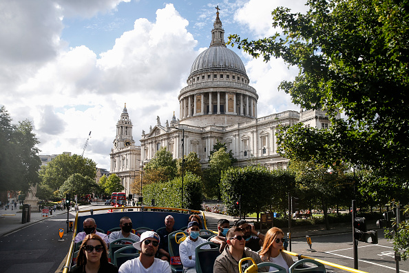LONDON, ENGLAND - AUGUST 22: Tourists pass St. Paul's Cathedral on a sightseeing bus on August 22, 2020 in London, England. Whilst the UK is open for business to overseas customers, continental European cities are seeing more holiday visitors than in London, which usually sees a booming summer tourism season, but is now hard hit from the effects of the closings of this year’s coronavirus pandemic.(Photo by Hollie Adams/Getty Images)