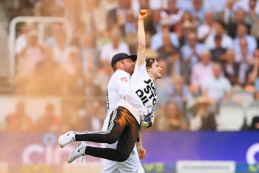 LONDON, ENGLAND - JUNE 28: Jonny Bairstow of England removes a "Just Stop Oil" pitch invader during Day One of the LV= Insurance Ashes 2nd Test match between England and Australia at Lord's Cricket Ground on June 28, 2023 in London, England. (Photo by Stu Forster/Getty Images)