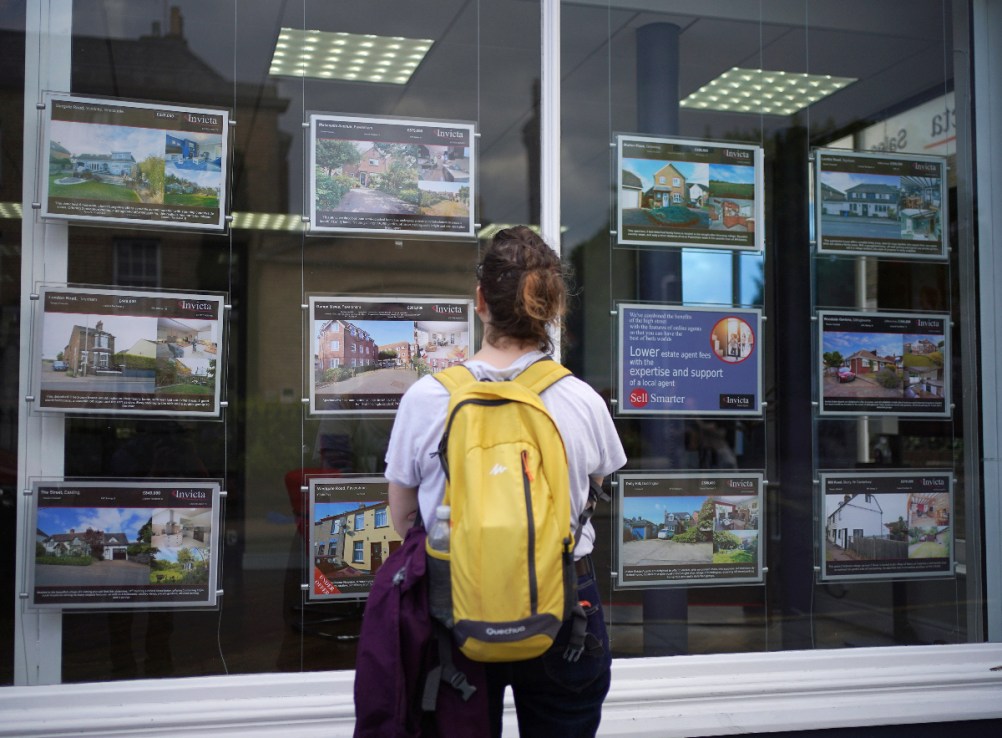 Woman looking at advertisements in an estate agents window. As many as 426,000 fewer first-time buyers in England could get on the property ladder between this year and 2027  (Photo credit: Yui Mok/PA Wire)