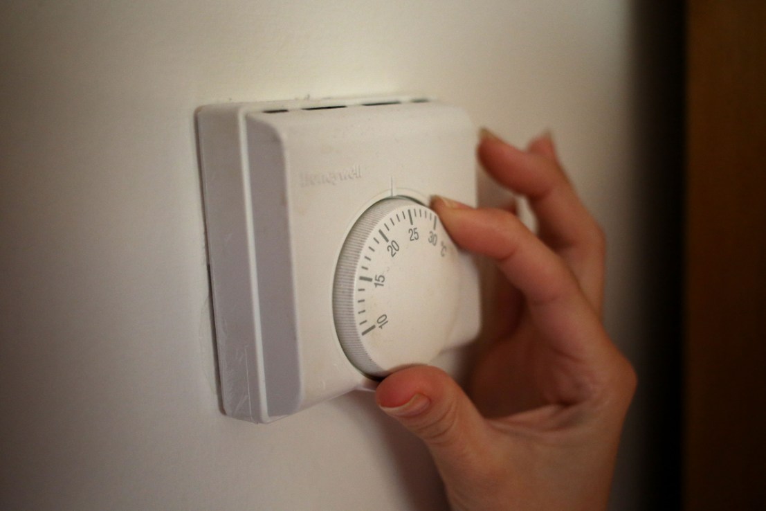 Person using a central heating thermostat, as a fall in Ofgem's energy price cap takes effect this weekend amid concerns households could still end up paying around 13% more than last winter.  (Photo credit: Steve Parsons/PA Wire)