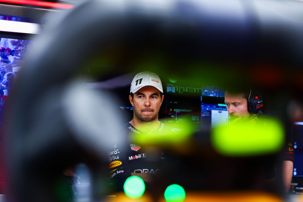 MEXICO CITY, MEXICO - OCTOBER 28: Sergio Perez of Mexico and Oracle Red Bull Racing looks on in the garage during qualifying ahead of the F1 Grand Prix of Mexico at Autodromo Hermanos Rodriguez on October 28, 2023 in Mexico City, Mexico. (Photo by Mark Thompson/Getty Images)