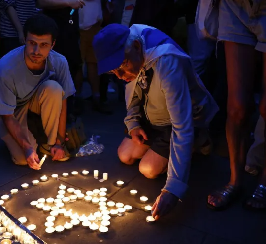 Members of the Jewish community light candles during a vigil for Israel at Downing Street.
