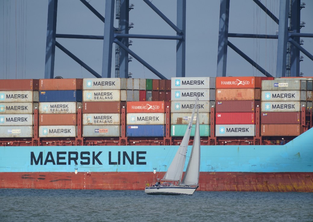 A yacht sailing past the container ship Vuoksi Maersk being loaded at the Port of Felixstowe, in Felixstowe, Suffolk, seen from Harwich, Essex. (Yui Mok/PA Wire)