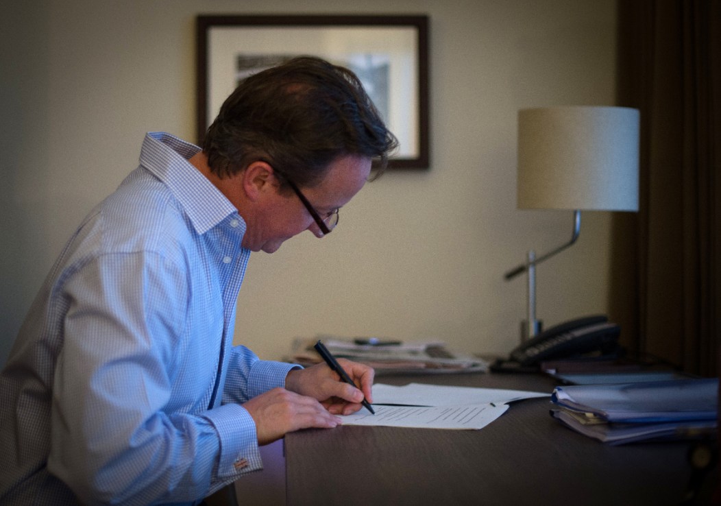 David Cameron preparing his keynote speech in his hotel in 2014 (Stefan Rousseau/PA Wire)