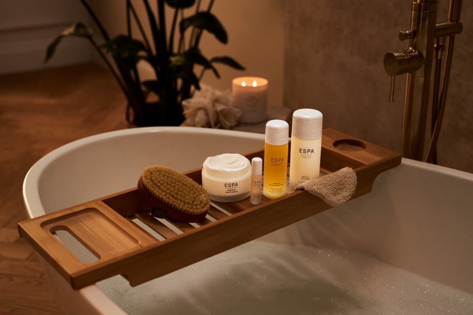 ESPA skin and body products arranged on a bath tray.