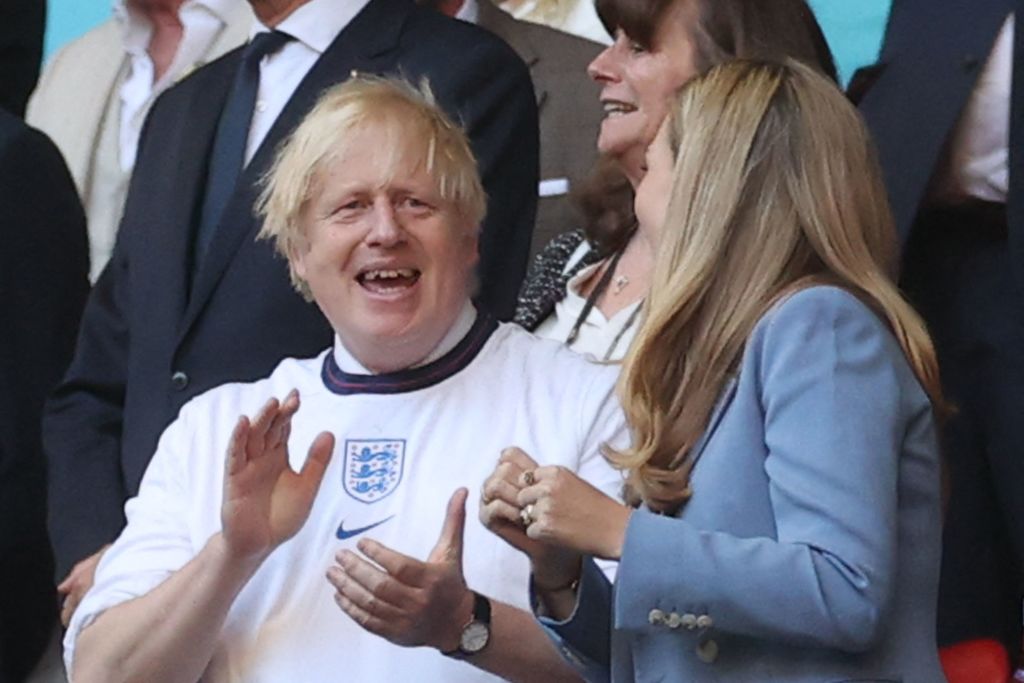 UK Prime Minister Boris Johnson and his spouse Carrie (R), are pictured ahead of the UEFA EURO 2020 semi-final football match between England and Denmark at Wembley Stadium in London on July 7, 2021. (Photo by CARL RECINE / POOL / AFP) (Photo by CARL RECINE/POOL/AFP via Getty Images)