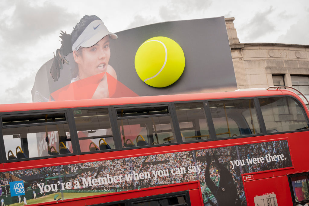 British tennis player, Emma Raducanu who is sponsored by HSBC appears on a giant billboard below an American Express bus ad in Wimbledon town centre, during the first week of competition of the Wimbledon Lawn Tennis Association championships, on 30th June 2022, in London, England. Raducanu, whose parents both work in the financial industry, already has sponsorship deals with Porsche, Tiffany and Co, British Airways, Evian, Dior and Vodafone. HSBC is also a major Wimbledon sponsor but a UK parliamentarian group has called on Wimbledon to drop the brand over the banks support of the controversial national security law in Hong Kong. (Photo by Richard Baker / In Pictures via Getty Images)