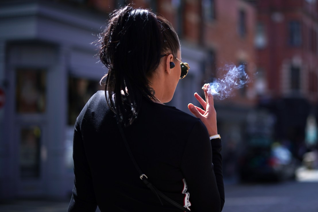 MANCHESTER, UNITED KINGDOM - APRIL 23: A woman smokes a cigarette in the spring sunshine as pandemic lockdown restrictions ease in Manchester's Northern Quarter on April 23, 2021 in Manchester, United Kingdom. (Photo by Christopher Furlong/Getty Images)
