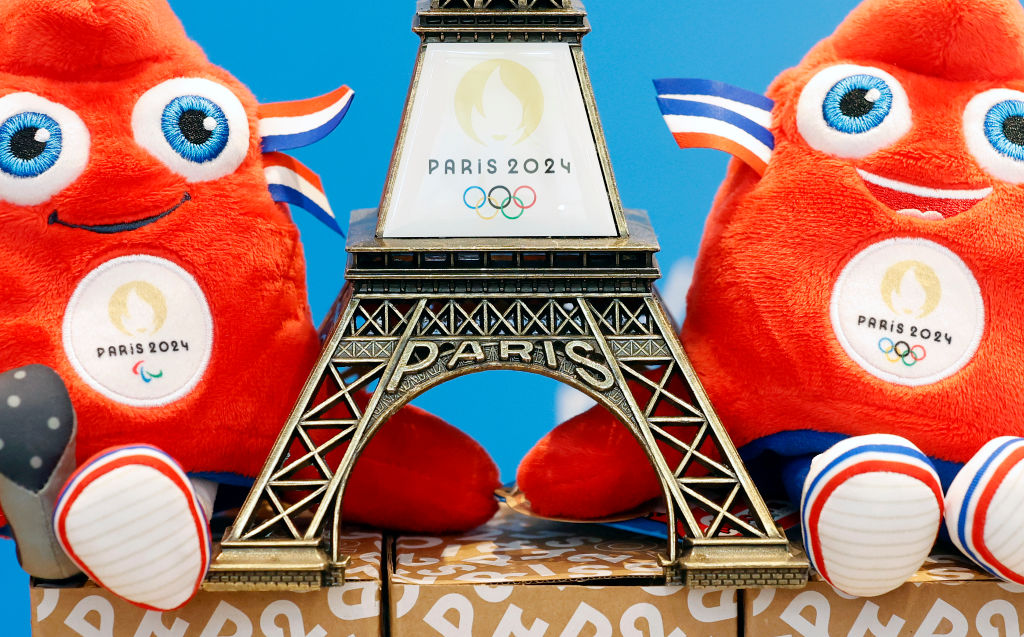 PARIS, FRANCE - NOVEMBER 15: A replica of the Eiffel Tower with the logo of the 2024 Olympic Games surrounded by official mascots for the Paris 2024 Summer Olympic and Paralympic Games is displayed inside the official store entirely dedicated to the 2024 Olympic Games on November 15, 2022 in Paris, France. The public will be able to acquire a large number of official products around the Olympic and Paralympic Games, mugs, t-shirts, pins and other goodies. The mascot represented by a red cap modelled on phrygian caps has been the symbol of freedom since the French Revolution and is still worn by the figure of Marianne, the national personification of France since that time. (Photo by Chesnot/Getty Images)