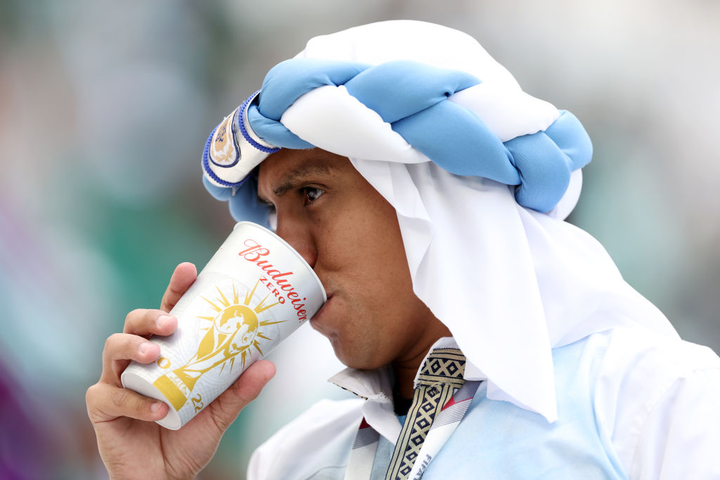 LUSAIL CITY, QATAR - NOVEMBER 22: A fan drinks from a Budweiser cup prior to the FIFA World Cup Qatar 2022 Group C match between Argentina and Saudi Arabia at Lusail Stadium on November 22, 2022 in Lusail City, Qatar. (Photo by Clive Brunskill/Getty Images)