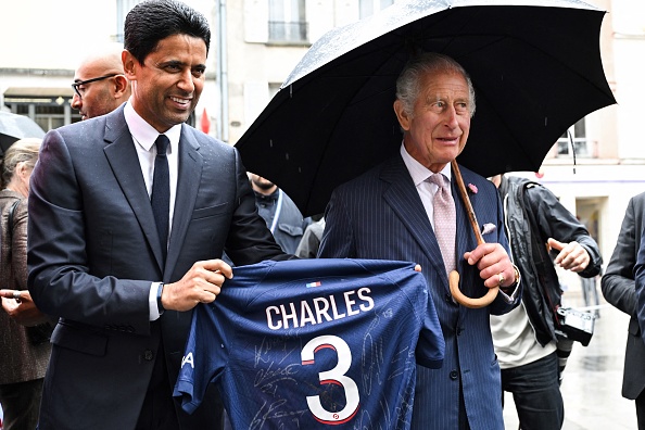 Paris Saint Germain's Qatari president Nasser al-Khelaifi offers Britain's King Charles III a Paris Saint Germain's jersey during a visit in Saint-Denis, northern suburb of Paris, home of the Rugby World Cup village, national stadium and venue for next year's Olympic Games, on September 21, 2023. Britain's King Charles III and his wife Queen Camilla are on a three-day state visit starting on September 20, 2023,  to Paris and Bordeaux, six months after rioting and strikes forced the last-minute postponement of his first state visit as king. (Photo by Bertrand GUAY / POOL / AFP) (Photo by BERTRAND GUAY/POOL/AFP via Getty Images)