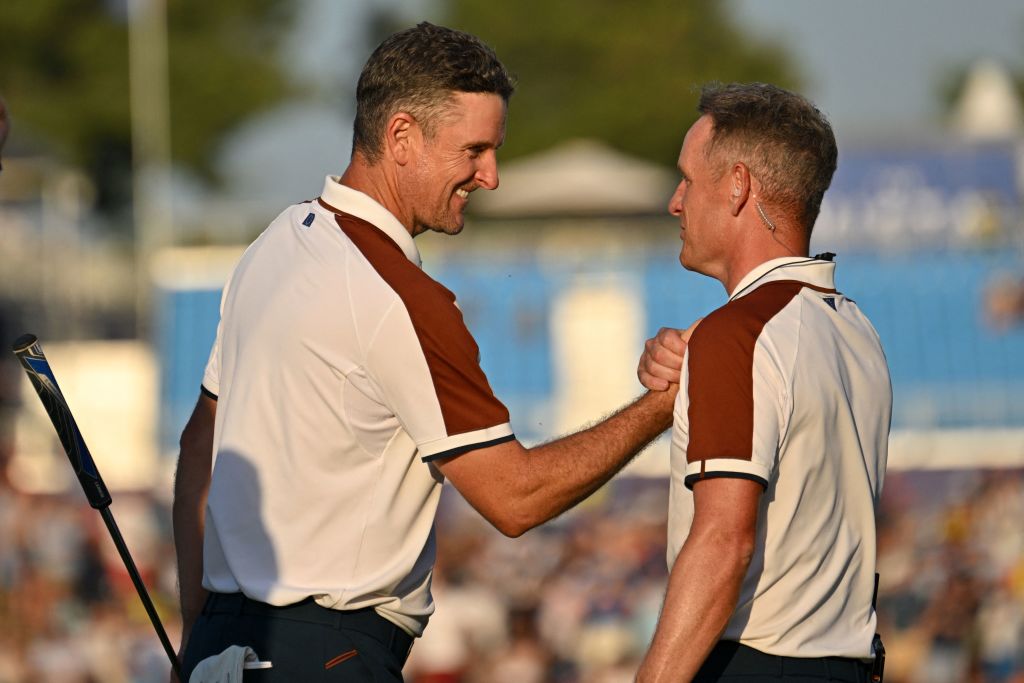 TOPSHOT - Europe's English golfer, Justin Rose (L) is congratulated by Europe's English captain, Luke Donald (R) after holing his birdie putt to secure the win on the 16th green during his four-ball match on the second day of play in the 44th Ryder Cup at the Marco Simone Golf and Country Club in Rome on September 30, 2023. (Photo by Alberto PIZZOLI / AFP) (Photo by ALBERTO PIZZOLI/AFP via Getty Images)