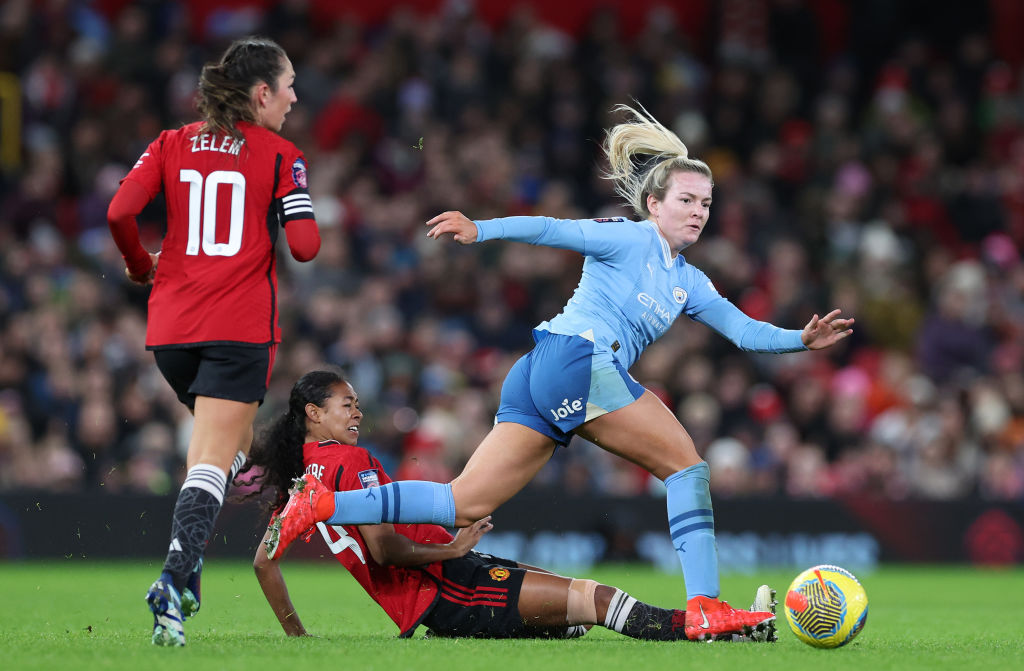 MANCHESTER, ENGLAND - NOVEMBER 19: Lauren Hemp of Manchester City is tackled by Jayde Riviere of Manchester United during the Barclays Women's Super League match between Manchester United and Manchester City at Old Trafford on November 19, 2023 in Manchester, England. (Photo by Alex Livesey - The FA/The FA via Getty Images)