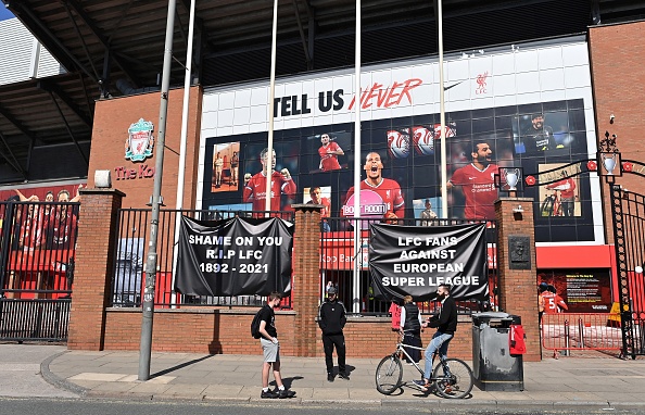 Anti-European Super League posters hang outside Anfield stadium, home of English Premier League football club Liverpool, in Liverpool, north west England on April 19, 2021. - Fan of the six Premier League clubs leading the breakaway European Super League have slammed the controversial plan, branding it the "ultimate betrayal". Liverpool, Manchester United, Arsenal, Chelsea, Manchester City and Tottenham are all involved in the new league, alongside Spanish trio Real Madrid, Barcelona, Atletico Madrid and Italian clubs Juventus, Inter Milan and AC Milan. (Photo by Paul ELLIS / AFP) (Photo by PAUL ELLIS/AFP via Getty Images)