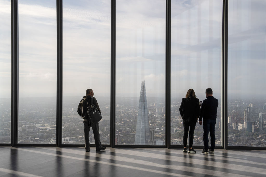People look out at the London skyline, with The Shard visible. (Photo by Carl Court/Getty Images)