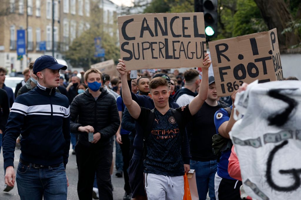 Football supporters demonstrate against the proposed European Super League outside of Stamford Bridge football stadium in London on April 20, 2021, ahead of the English Premier League match between Chelsea and Brighton and Hove Albion. - Reports on Tuesday evening suggested that cracks were appearing in the plan with some clubs having second thoughts in the face of the outrage. British media named Chelsea as one team that could be on the brink of pulling out of the project. (Photo by Adrian DENNIS / AFP) (Photo by ADRIAN DENNIS/AFP via Getty Images)