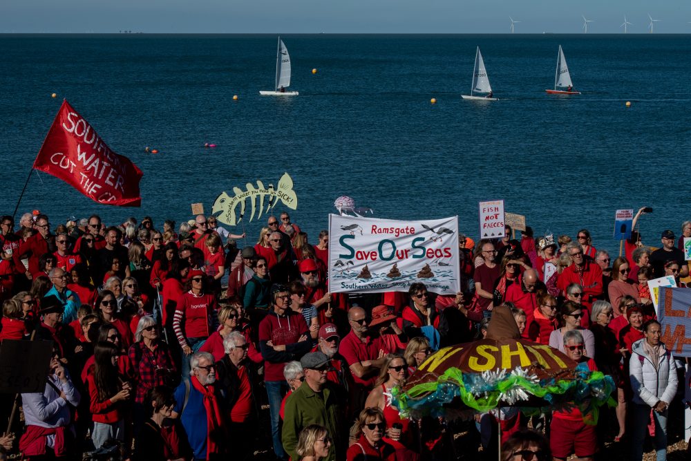 WHITSTABLE, ENGLAND - OCTOBER 09: People gather on Tankerton beach to protest against sewage discharges by Southern Water on October 9, 2022 in Whitstable, England. The regional wastewater treatment company, Southern Water, has been under scrutiny for its practices of releasing untreated sewage in the waters off the Kent coast. (Photo by Chris J Ratcliffe/Getty Images)