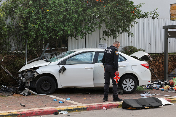 A member of Israeli police inspects a damaged car following a suspected ramming attack in the central town of Raanana, on January 15, 2024. (Photo by JACK GUEZ / AFP) (Photo by JACK GUEZ/AFP via Getty Images)