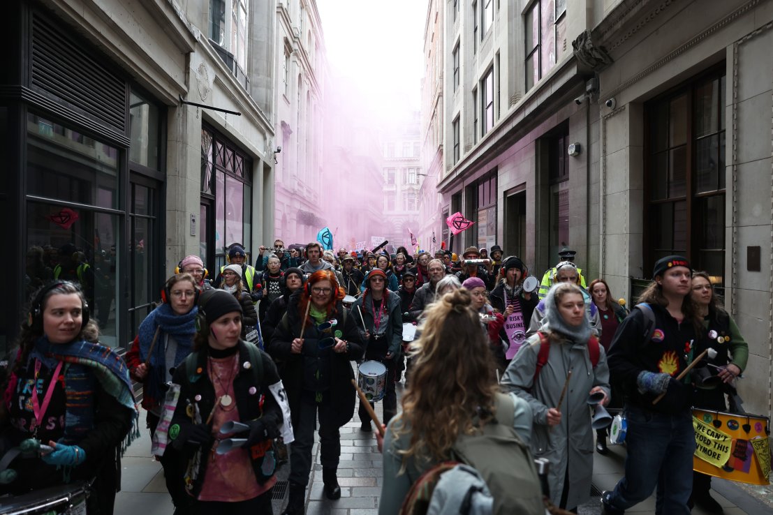 Extinction Rebellion activists walk through the City of London on Tuesday 27 February, after insurers were targeted across the Square Mile. (Credit: XR)