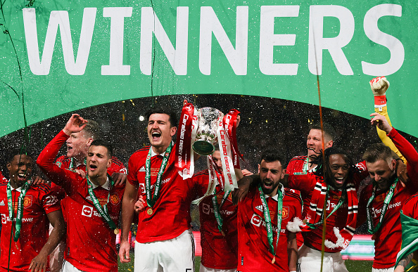 LONDON, ENGLAND - FEBRUARY 26: Harry Maguire of Manchester United celebrates with the trophy among team mates during the Carabao Cup Final match between Manchester United and Newcastle United at Wembley Stadium on February 26, 2023 in London, England. (Photo by Marc Atkins/Getty Images)