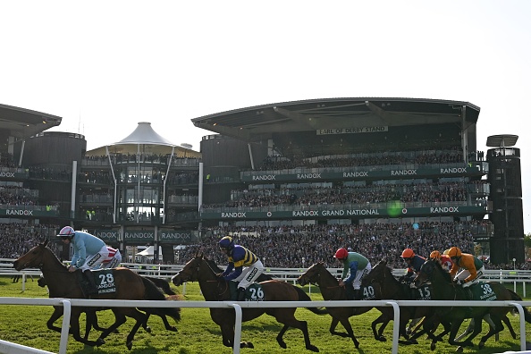 Jockey Derek Fox riding eventual winner Corach Rambler (C) with the leaders at the start of the second lap in the Grand National Steeple Chase on the final day of the Grand National Festival horse race meeting at Aintree Racecourse in Liverpool, north-west England, on April 15, 2023. (Photo by Paul ELLIS / AFP) (Photo by PAUL ELLIS/AFP via Getty Images)