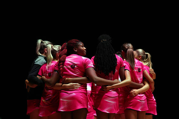 NOTTINGHAM, ENGLAND - FEBRUARY 11: Halimat Adio of London Pulse looks on with her team during a huddle during the Netball Super League 2023 Season Opener at Motorpoint Arena Nottingham on February 11, 2023 in Nottingham, England. (Photo by Naomi Baker/Getty Images for England Netball)