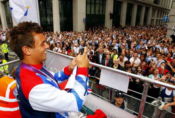 LONDON, ENGLAND - SEPTEMBER 10:  British Olympic diver Tom Daley films the crowd with his phone during the London 2012 Victory Parade for Team GB and Paralympic GB athletes on September 10, 2012 in London, England.  (Photo by David Davies - WPA Pool/Getty Images)