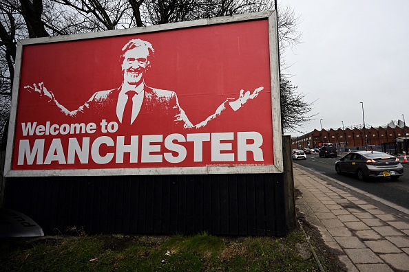 A photograph taken on February 4, 2024 shows a billboard depicting INEOS Chairman and Manchester United shareholder Sir Jim Ratcliffe, near Old Trafford stadium, in Manchester. (Photo by Paul ELLIS / AFP) (Photo by PAUL ELLIS/AFP via Getty Images)