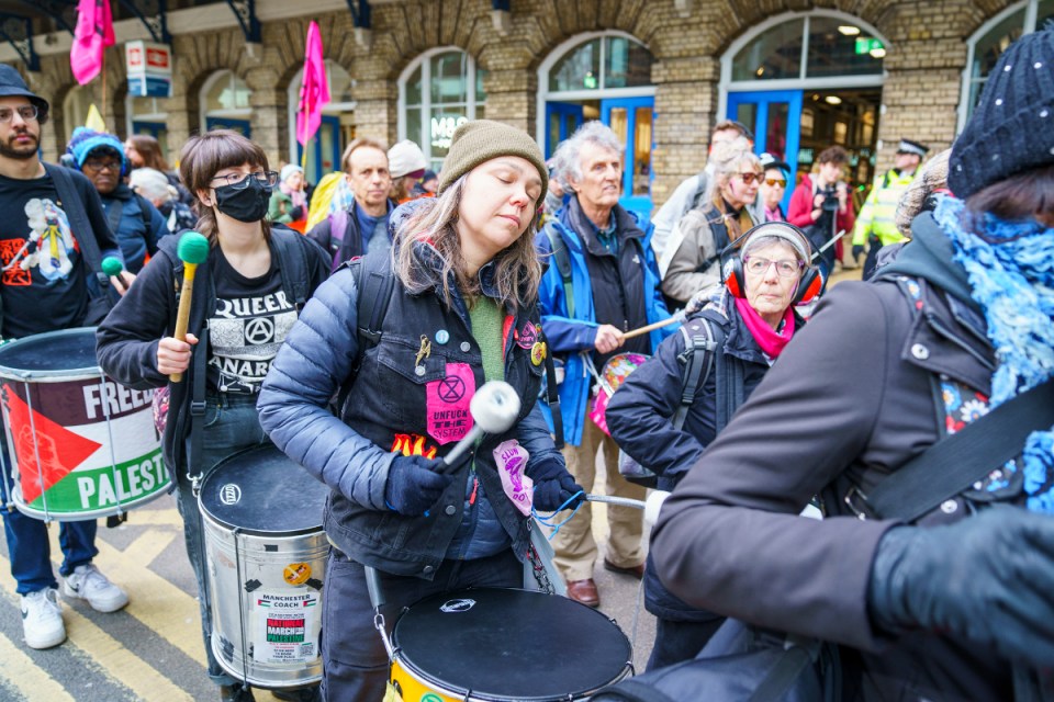 Extinction Rebellion activists walk through the City of London on Tuesday 27 February, with some also campaigning for Palestine. 