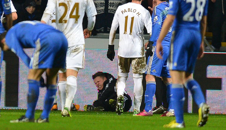 A ballboy (C) lies on the grounf and reacts after a altercation with Chelsea's Belgium midfielder Eden Hazard during the English League Cup semi-final second leg football match between Swansea City and Chelsea at The Liberty stadium in Cardiff, south Wales on January 23, 2013. After the incident Hazard was sent off by referee Chris Foy. AFP PHOTO/ANDREW YATES