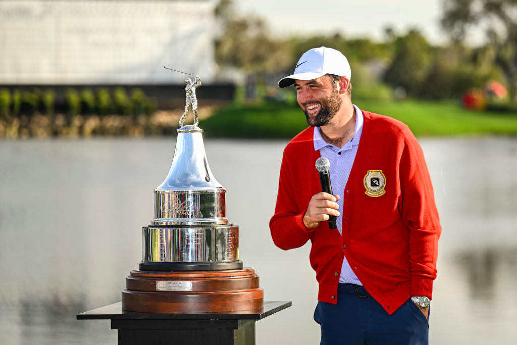 ORLANDO, FLORIDA - MARCH 10:  Scottie Scheffler smiles next to the tournament trophy following his five stroke victory in the final round of the Arnold Palmer Invitational presented by Mastercard at Bay Hill Club and Lodge on March 10, 2024 in Orlando, Florida. (Photo by Keyur Khamar/PGA TOUR via Getty Images)