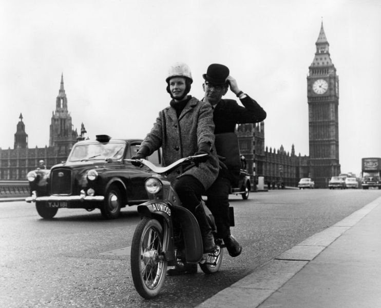 A moped taxi on a test run over Westminster Bridge, London.