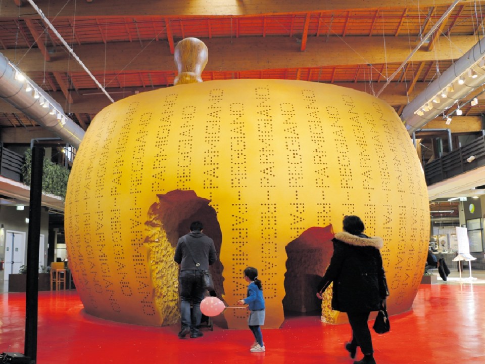 A many times larger than life wheel of parmesan cheese at FICO Eataly in Bologna
