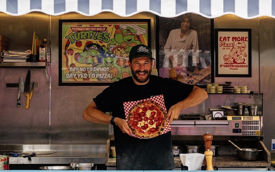 Nick Ingham, owner of It’s Not Big Dough, makes pizza from a container in Blackhorse Road